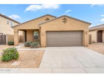 Charming single-story home featuring a two-car garage and low-maintenance desert landscaping in a residential neighborhood at 951 E Jacob St, Chandler, AZ 85225
