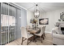 Stylish dining area with modern chandelier, seating for six, and natural light at 15252 N 100Th St # 1154, Scottsdale, AZ 85260