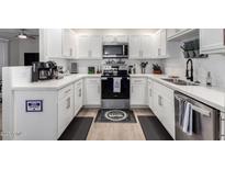 Bright kitchen features white cabinetry, stainless steel appliances, and modern countertops at 15252 N 100Th St # 1154, Scottsdale, AZ 85260