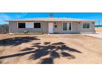 Charming single-story home featuring a neutral color scheme and well-lit exterior under a clear blue sky at 3212 N 49Th Ln, Phoenix, AZ 85031