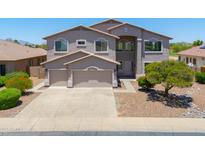 Inviting two-story home featuring a three-car garage and desert landscaping for low maintenance at 43324 W Desert Fairways Dr, Maricopa, AZ 85138