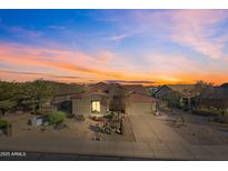 Charming desert home features a tile roof, mature landscaping, and a welcoming two-car garage at 7145 E Cuernavaco Way, Gold Canyon, AZ 85118