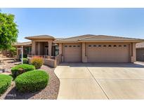 Attractive single-story home featuring a three-car garage and desert landscaping at 10903 E Ocaso Ave, Mesa, AZ 85212