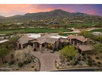 Expansive estate with lush landscaping, desert vegetation, mountain views, and a circular driveway at 11240 E Apache Vistas Dr, Scottsdale, AZ 85262