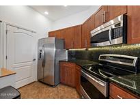 Modern kitchen featuring stainless steel appliances, granite countertops, and ample cabinet space at 11640 N Tatum Blvd # 3091, Phoenix, AZ 85028