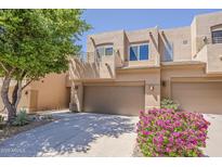 South Scottsdale two-story townhome with a two-car garage, balcony, desert landscaping and block construction at 11752 N 135Th Pl, Scottsdale, AZ 85259