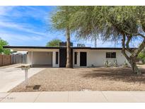 Charming single-story home featuring a xeriscaped yard, carport, and painted brick exterior at 11842 N 30Th Dr, Phoenix, AZ 85029