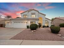 Charming two-story home featuring a well-manicured front yard with mature landscaping and a three car garage at 14862 N 90Th Pl, Scottsdale, AZ 85260