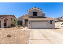 Two-story home featuring neutral paint, tile roof, and a spacious two-car garage and low maintenance desert landscaping at 15808 N 164Th Ln, Surprise, AZ 85388