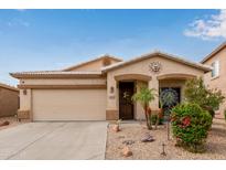 Charming single-story home with a well-manicured yard, desert landscaping, and a two-car garage at 318 E Taylor Trl, San Tan Valley, AZ 85143