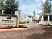 A view of the entrance to the Phoenician Pines Condominium Homes, surrounded by lush landscaping at 3420 W Danbury Dr # C130, Phoenix, AZ 85053