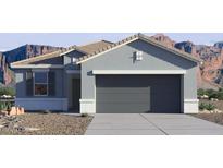 A single-story home with a gray exterior, two-car garage, desert landscaping, and a mountain backdrop at 35500 N Common Ct, San Tan Valley, AZ 85140