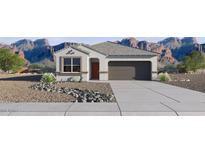Charming single story home showcasing desert landscaping and a two car garage at 35545 N Breezy Ln, San Tan Valley, AZ 85140