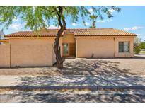 Charming single-story home with a well-maintained desert landscape and a classic tile roof at 4353 E Desert Wind Dr, Phoenix, AZ 85044
