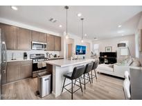 Open concept kitchen with an island, pendant lighting, and stainless steel appliances at 4803 S Ferric --, Mesa, AZ 85212