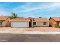 Charming single-story home with a well-manicured lawn and a two-car garage at 6416 S 19Th Pl, Phoenix, AZ 85042