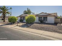 Charming single-story home featuring mature landscaping and a well-maintained front yard at 12154 S Ki Rd, Phoenix, AZ 85044