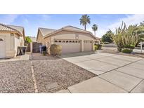 Charming home featuring a two-car garage, desert landscaping, and spacious driveway at 1413 E San Remo Ave, Gilbert, AZ 85234