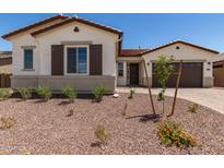 Charming single-story home featuring desert landscaping, a cozy front porch, and a two-car garage at 20255 W Monterey Way, Buckeye, AZ 85396