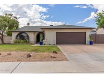 Charming single-story home with a well-maintained front yard and a two-car garage at 2109 W El Alba Way, Chandler, AZ 85224