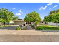 Charming single-story home boasts mature trees, a well-manicured lawn, and inviting curb appeal at 315 E Marlette Ave, Phoenix, AZ 85012