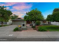 Charming single-story home with mature trees and a well-maintained front yard at 315 E Marlette Ave, Phoenix, AZ 85012