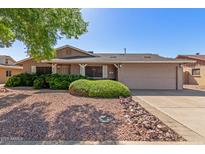 Traditional home showcasing desert landscaping, concrete driveway, and attached two-car garage at 3526 N 85Th St, Scottsdale, AZ 85251