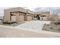 Stunning modern home with a spacious driveway and desert landscaping at 37200 N Cave Creek Rd # 1013, Scottsdale, AZ 85262