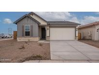 Charming single-story home with a two-car garage and neutral-toned exterior at 39965 W Bunker Dr, Maricopa, AZ 85138