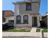 Two story home with tan stucco and brown trimmed windows and door at 5311 W Fulton St, Phoenix, AZ 85043