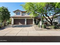 Charming two-story home with a three-car garage and desert landscaping at 7336 E Overlook Dr, Scottsdale, AZ 85255