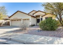 Charming single-story home featuring a three-car garage and a well-maintained, low-water landscape at 809 S 120Th Ave, Avondale, AZ 85323
