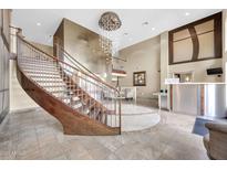 Grand lobby featuring a curved staircase, stylish chandelier, and concierge desk at 945 E Playa Del Norte Dr # 1003, Tempe, AZ 85288