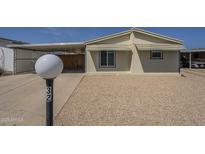 Charming home featuring a carport, low-maintenance landscaping and neutral tones at 10951 N 91St Ave # 32, Peoria, AZ 85345