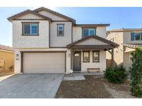 Charming two-story home with landscaped yard, a covered entryway, and an attached two-car garage at 10983 W Mckinley St, Avondale, AZ 85323