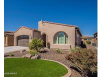 Charming single-story home with desert landscaping and an arched window at 132 E El Prado Dr, Queen Creek, AZ 85140