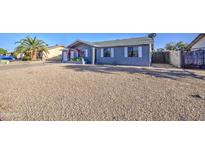Charming single-story home with a gravel yard and a lovely floral archway entrance at 1529 W Wickieup Ln, Phoenix, AZ 85027