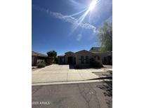 Single-story home with arched entryway, well-maintained landscaping, and concrete driveway at 17447 W Yavapai St, Goodyear, AZ 85338