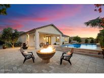 Outdoor living space features a fire pit, pool, and covered patio with seating at 3912 E Ellis St, Mesa, AZ 85205