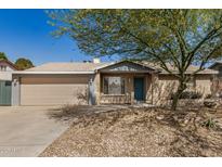 Charming single-story home with a well-maintained lawn, brick facade, and a two-car garage at 5423 S Palm Dr, Tempe, AZ 85283