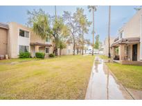 Cozy condos featuring lush green grounds and mature trees, offering a serene residential setting at 7126 N 19Th Ave # 122, Phoenix, AZ 85021