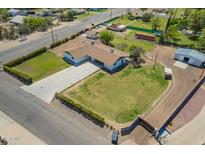 Sprawling property featuring a well-maintained yard, long driveway, and ample parking spaces at 15202 N 71St Dr, Peoria, AZ 85381
