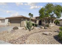 Charming single-story home with desert landscaping, boulders, and a neutral color palette at 15434 W Big Sky Dr, Surprise, AZ 85374