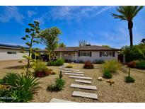 Charming single-story home featuring desert landscaping, a stone pathway, and a well-maintained front yard at 3015 E Sells Dr, Phoenix, AZ 85016