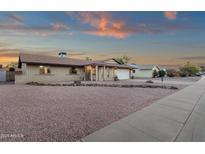 Charming single-story brick home with well-manicured desert landscaping and a two-car garage at 3121 E Sierra St, Phoenix, AZ 85028