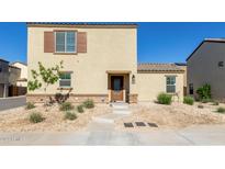 Charming two-story home featuring a neutral color scheme, landscaped front yard, and concrete walkway leading to the front door at 3929 S 79Th Ln, Phoenix, AZ 85043