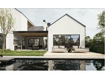 A modern backyard with pool, covered patio, outdoor kitchen, and stylish seating area at 4008 N 34Th St, Phoenix, AZ 85018