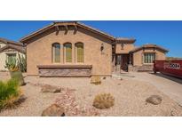 Charming single-story home featuring a desert landscaped front yard and a warm, stucco exterior at 464 W Bismark St, San Tan Valley, AZ 85143