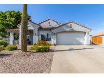 Charming single-story home with low maintenance front yard, desert landscaping and two car garage at 7908 W Rose Garden Ln, Peoria, AZ 85382