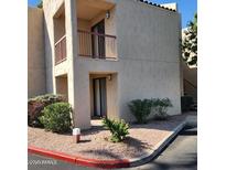 Exterior view of condo featuring balcony, desert landscaping, and neutral color scheme at 9340 N 92Nd St # 120, Scottsdale, AZ 85258